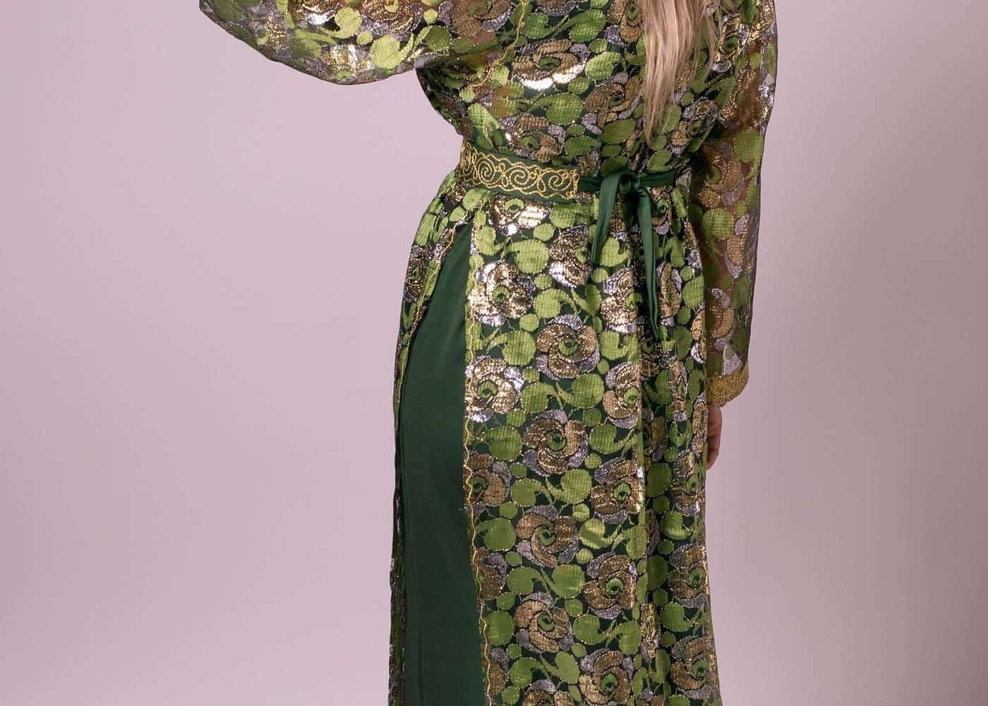 A woman in a green silk kaftan, seen from behind