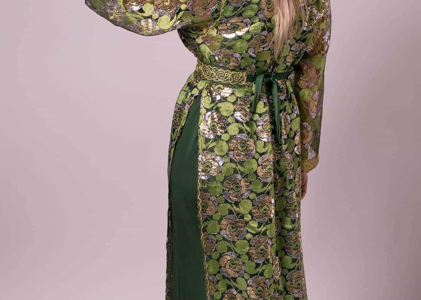 A woman in a green silk kaftan, seen from behind