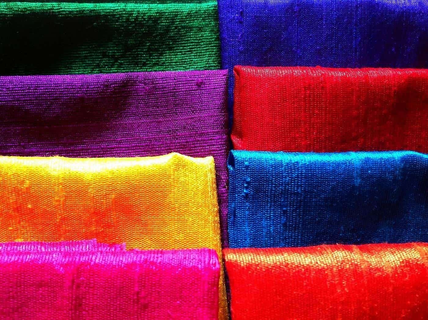 Bolts of brightly coloured dupioni silk fabric