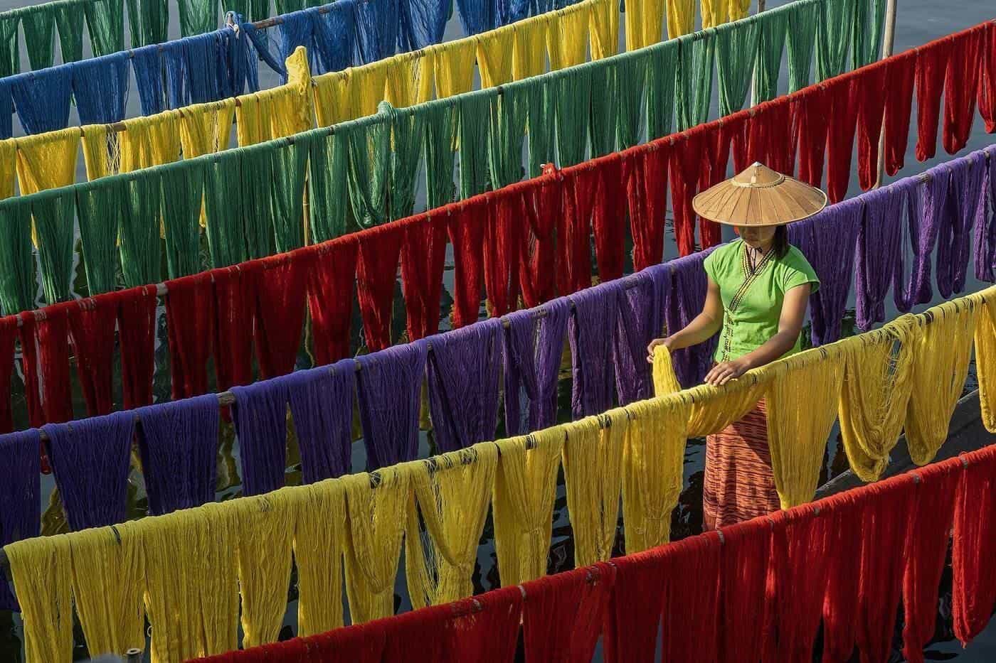 Rows of cotton-silk fabric hung out to dry in bright colours