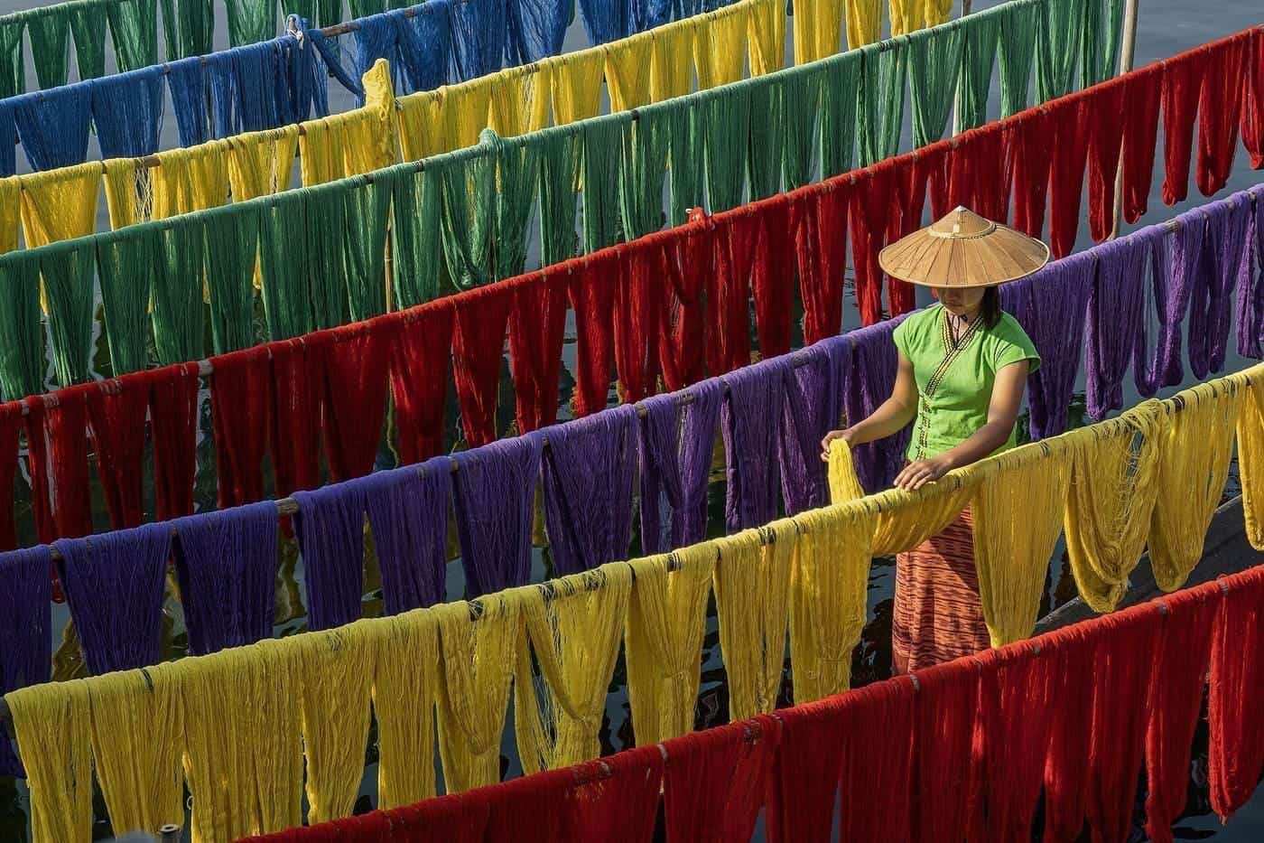 Rows of cotton-silk fabric hung out to dry in bright colours