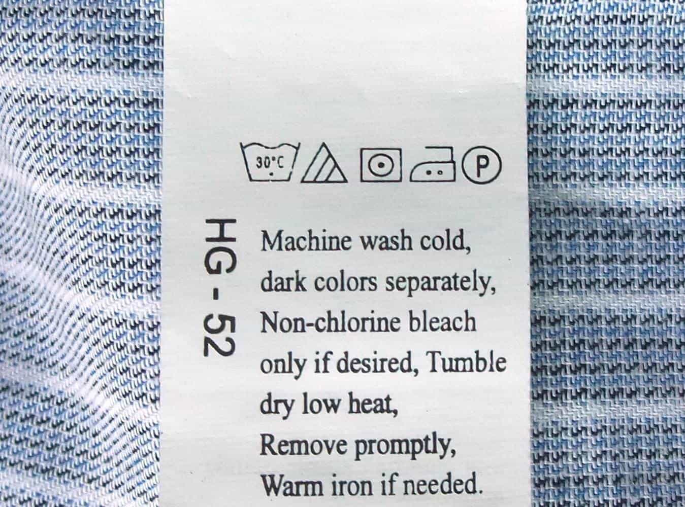 A care label with laundry symbols attached to a shirt