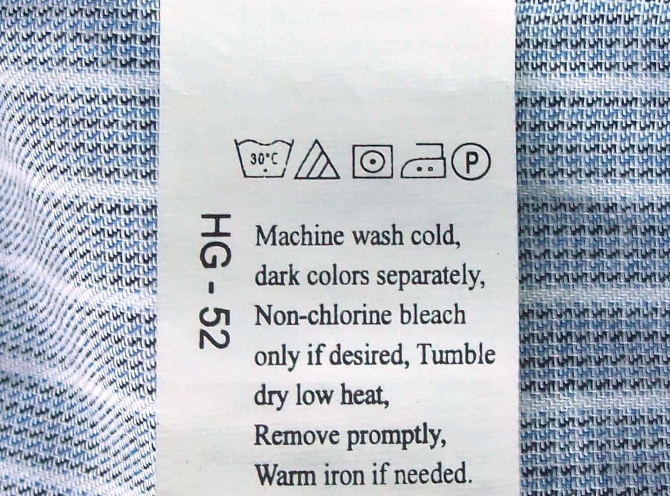 A care label with laundry symbols attached to a shirt