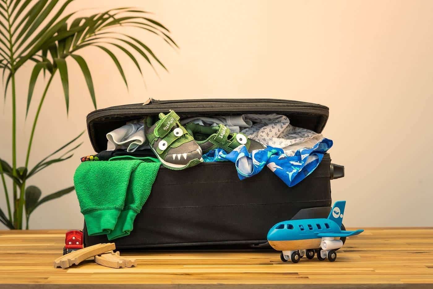 An overflowing suitcase being packed for a holiday